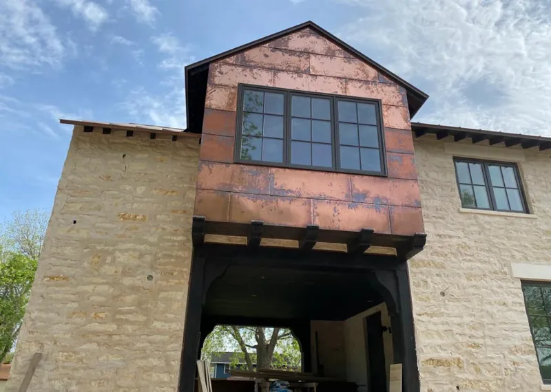 Copper metal panel facade on a stone building for Skylight Installation in Shoreview